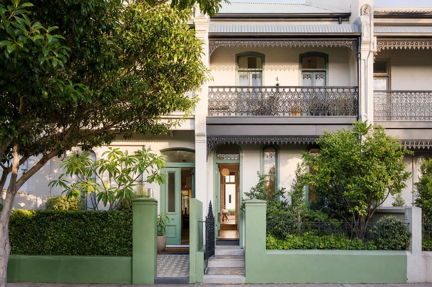 Green-trimmed Sydney terrace house in morning light